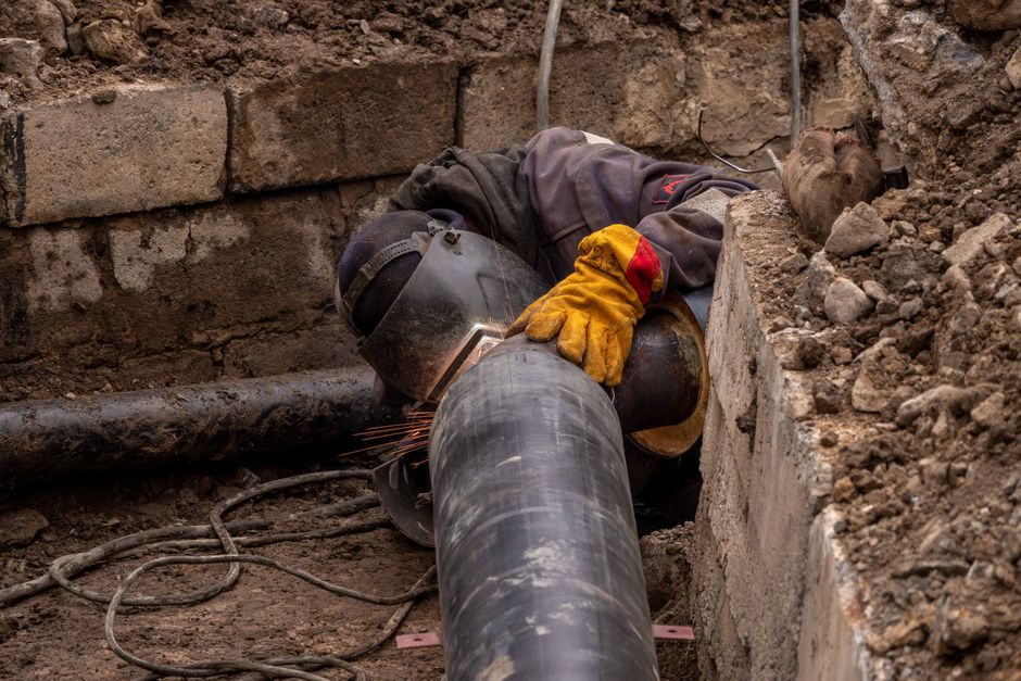 Close-up of drainage pipes showing repair and relining work in progress